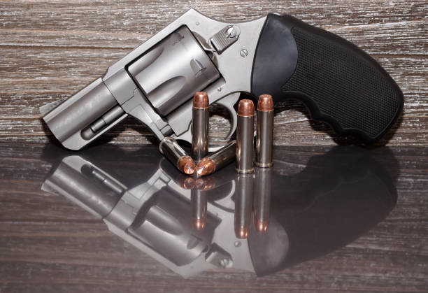 istock A stainless revolver with five bullets next to it 924649602