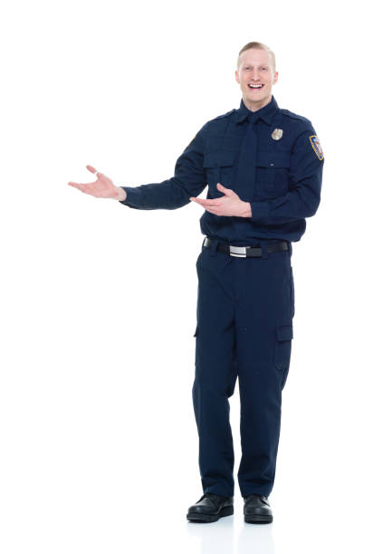 istock Handsome and friendly police officer presenting to the side 924649934
