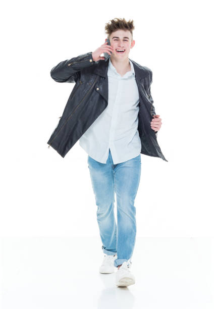 istock Attractive young man walking and talking on phone 924652498