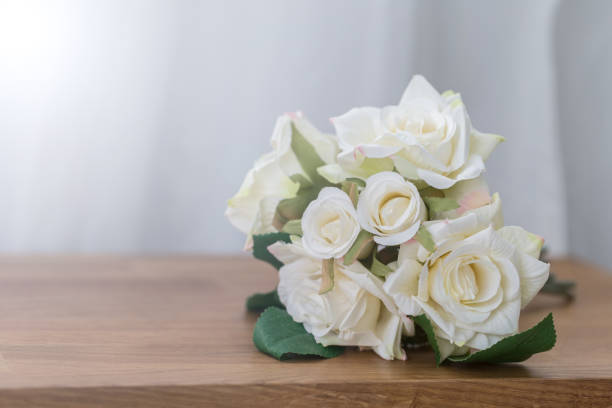 istock White rose flower on wooden chair with copy space 924652730