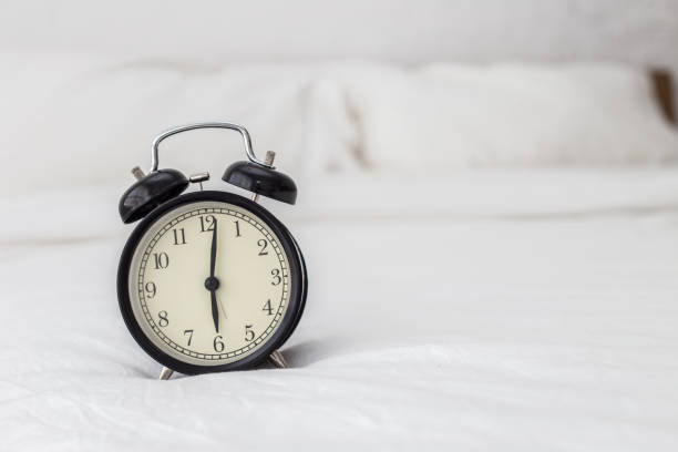 istock Alarm clock in bed room in 6 A.M. 924652754