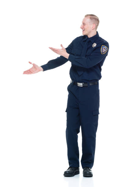 istock Handsome and friendly police officer presenting to the side 924655506