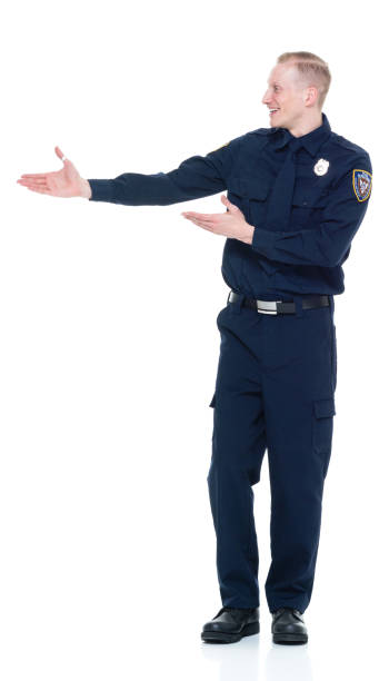 istock Handsome and friendly police officer presenting to the side 924655510