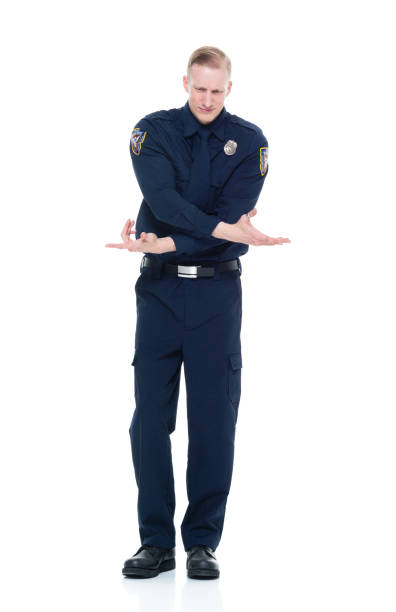 istock Handsome and friendly police officer confused pointing 924655960