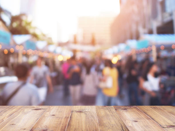 istock table top over abstract blurred background of people walking and shopping 924663014