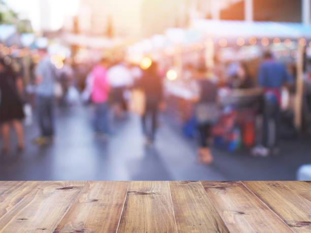 istock table top over abstract blurred background of people walking and shopping 924663106