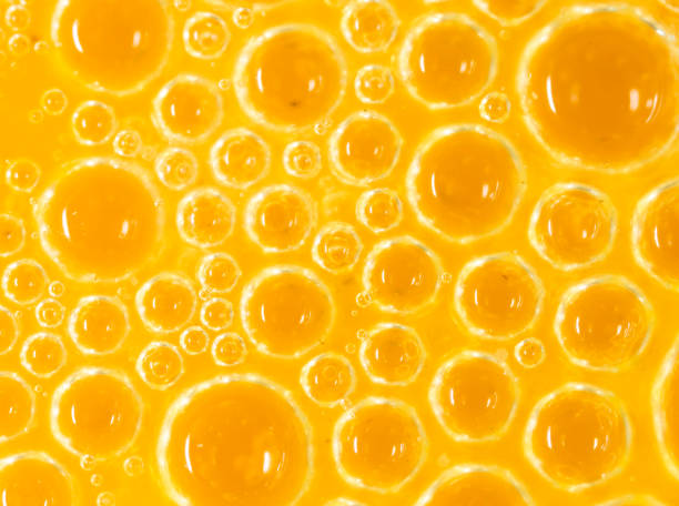 istock foam on a yellow egg yolk as a background. macro 924663738