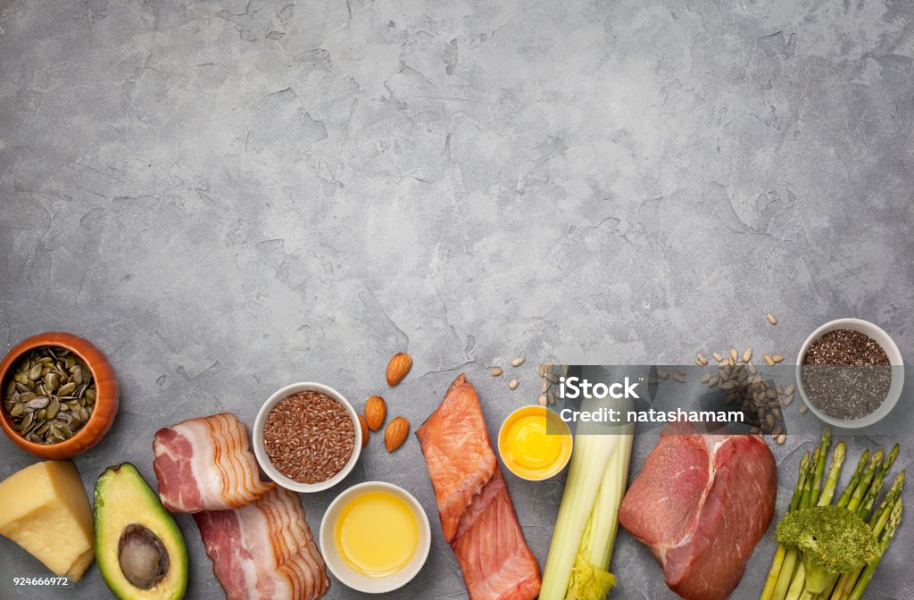 Ingredients for ketogenic diet Ingredients for ketogenic diet: meat, bacon, fish, broccoli, asparagus, avocado, mushrooms, cheese, sunflower seeds, chia seeds, pumpkin seeds, flax seeds. view from above. copy space Ketogenic Diet Stock Photo