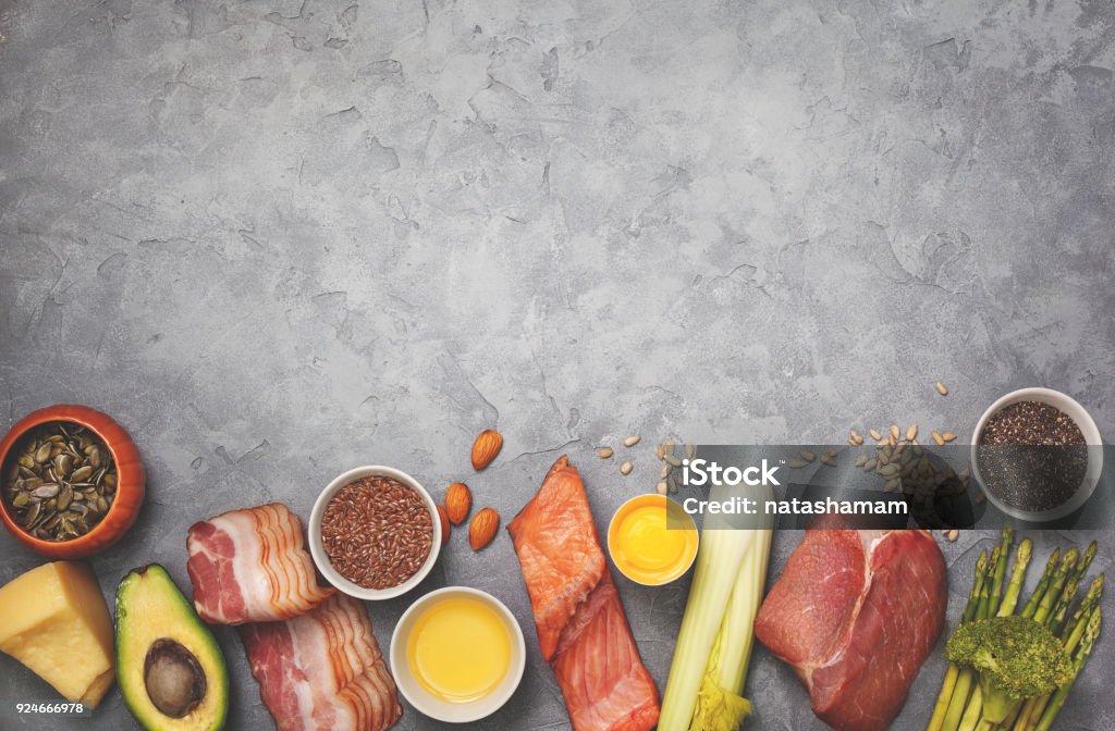 Ingredients for ketogenic diet Ingredients for ketogenic diet: meat, bacon, fish, broccoli, asparagus, avocado, mushrooms, cheese, sunflower seeds, chia seeds, pumpkin seeds, flax seeds. view from above. copy space. toning Ketogenic Diet Stock Photo