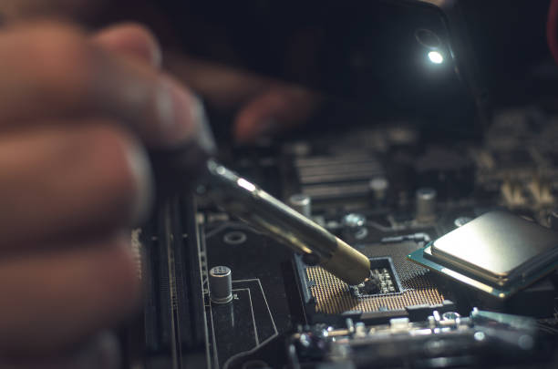 istock Computer repair man installing a CPU on mother board. Repair of central processor unit. 924667030