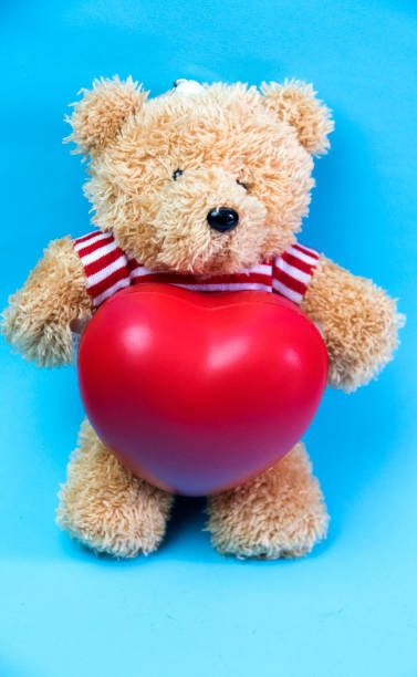 istock Little teddy bear , a valentine's gift for lover isolated on light blue background 924672548