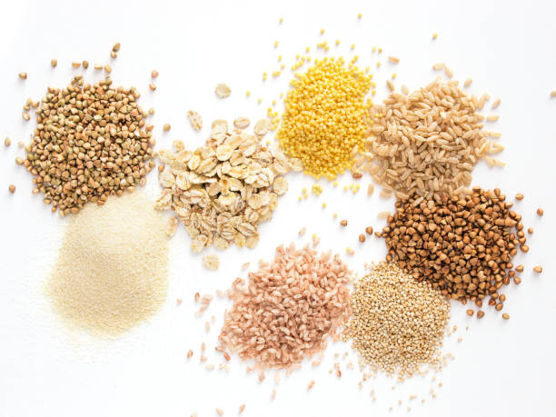 Set of heap various grains and cereals isolated Set of heap various grains and cereals - raw green buckwheat, semolina, oat flakes, millet, brown rice, buckwheat or kasha,quinoa, and red rice.Isolated on white with clipping path.Top view.Copy space rice cereal plant stock pictures, royalty-free photos & images