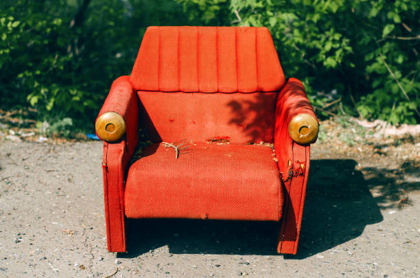istock Old retro armchair standing on green tree background. 924673344