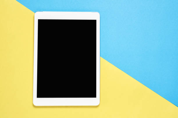 istock Top view, Modern workplace with tablet placed on a pastel yellow background. Copy space suitable for use in graphics. 924673362