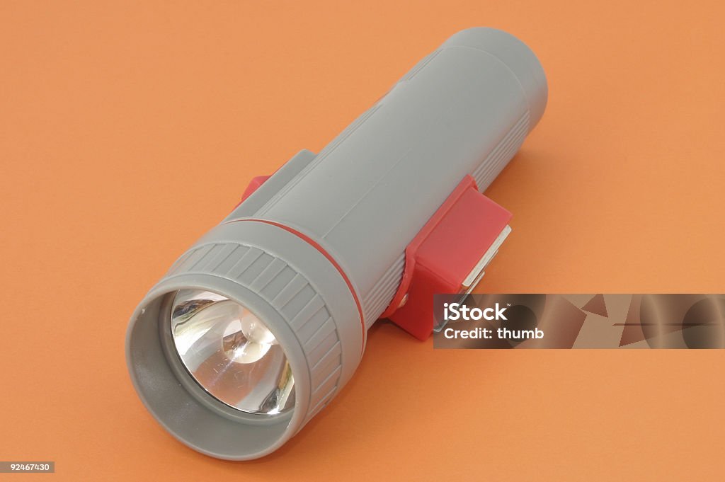 flashlight on orange  Flashlight Stock Photo