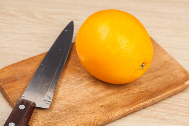 istock orange fruit knife on wooden 924676808