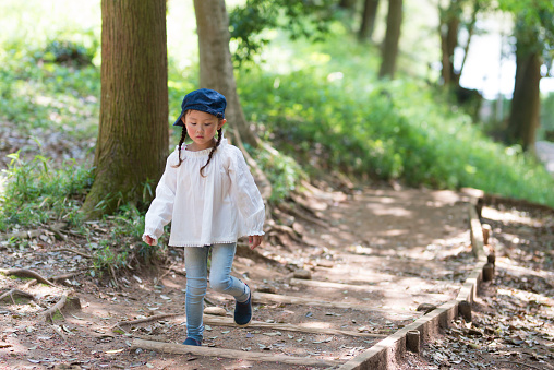 Little girl walking in the forest