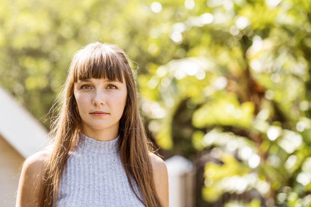 istock Thoughtful young woman looking away in backyard 924677652