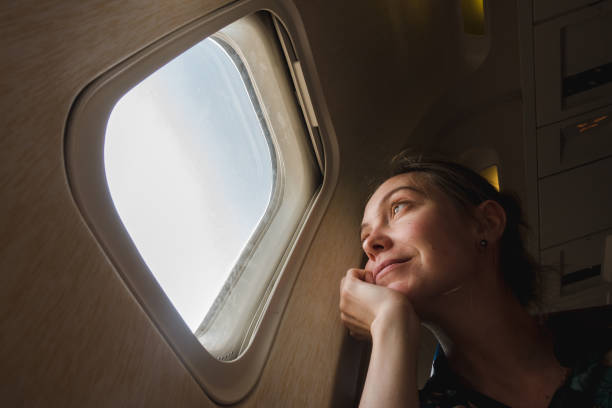 istock Woman at porthole in plane 924681764