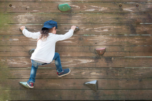 Little girl climbing the wall