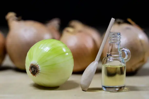 Photo of Onion the best specific  for influenza. Syrup prepared from onions. Black background.