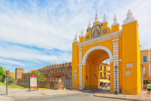 Seville, Spain- June 08, 2017 : Arco de la Macarena on Wall of Seville (Muralla almohade de Sevilla) are a series of defensive walls surrounding the Old Town of Seville. The city has been surrounded by walls since the Roman period.