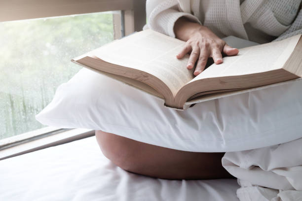 istock Woman in the bed and reading a book. 924694626