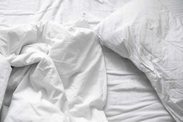 istock Top view. Close up unmade white bedding sheets and pillow, Messy bed after night sleep concept. textile background. illustration of a romantic date at a hotel, cheating 924695502