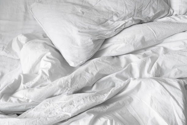 istock Top view. Close up unmade white bedding sheets and pillow, Messy bed after night sleep concept. textile background. illustration of a romantic date at a hotel, cheating 924697674