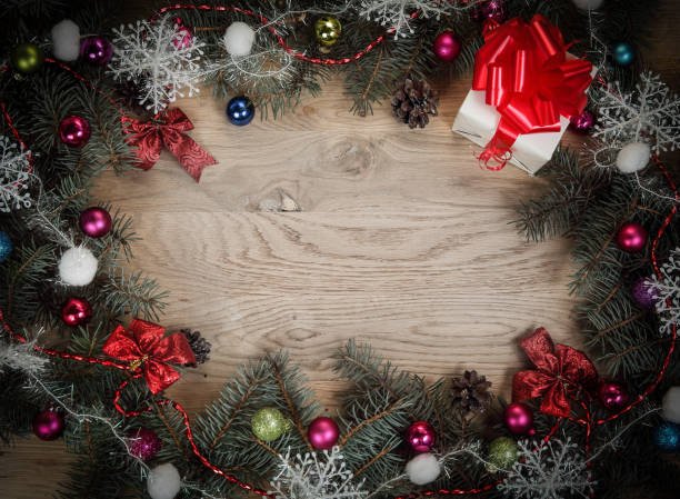 istock Christmas wreath and gift on wooden background 924697866