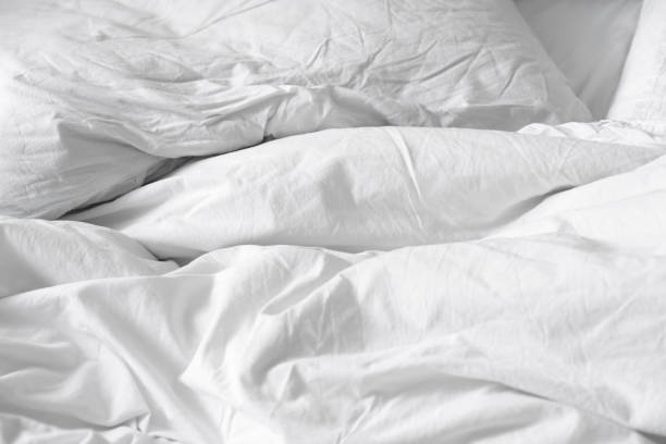 istock Top view. Close up unmade white bedding sheets and pillow, Messy bed after night sleep concept. textile background. illustration of a romantic date at a hotel, cheating 924698492