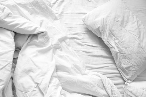 istock Top view. Close up unmade white bedding sheets and pillow, Messy bed after night sleep concept. textile background. illustration of a romantic date at a hotel, cheating 924698966