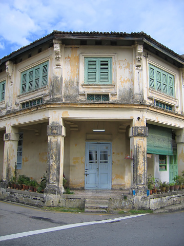 A rundown old Chinese house in the business district of Penang, Malaysia.