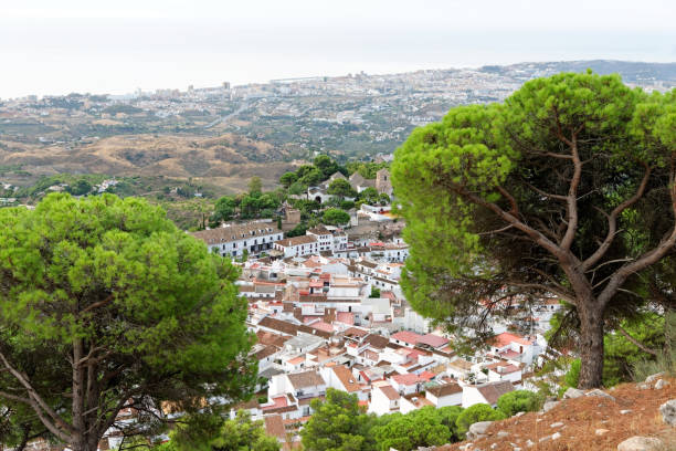 Panorama of white village of Mijas. Costa del Sol, Andalusia. Spain. Aerial view of the charming white village of Mijas in Andalusia, Costa del Sol, Southern Spain, seen from the Calvario Shrine on the Mijas mountain. Fuengirola in the background. mijas pueblo stock pictures, royalty-free photos & images