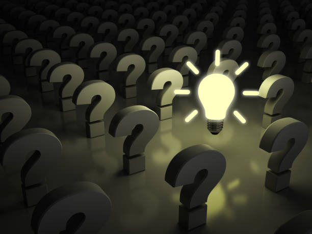 istock Idea bulb glowing in the dark among question marks 924709442
