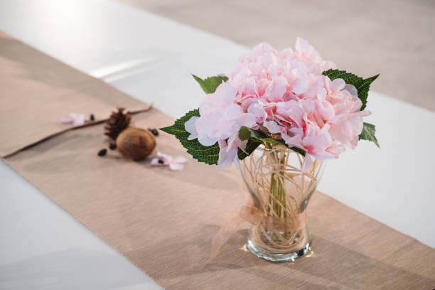 istock Table decoration, Pink flowers in vase on dining table 924710204