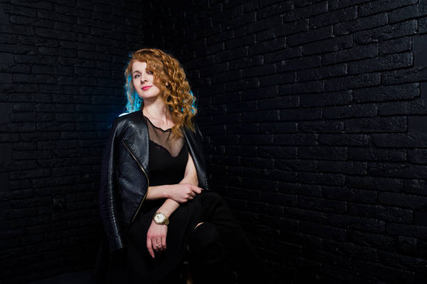 istock Curly hair girl on studio against black brick wall. 924715930