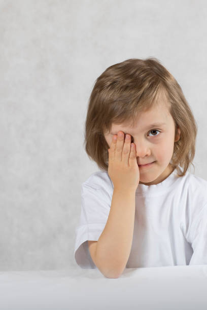 istock Boy of 5 years old closes one eye. 924716094
