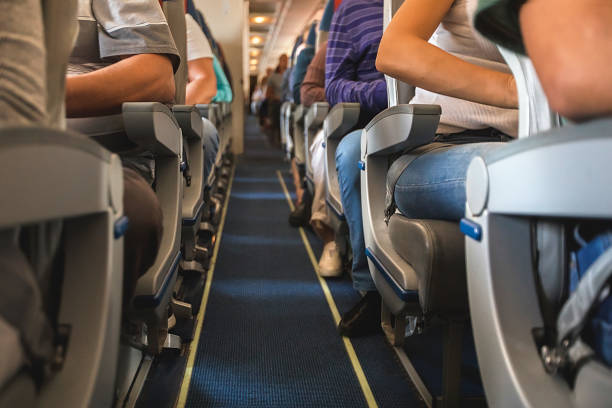 istock cabin of airplane with passengers on seats 924716614