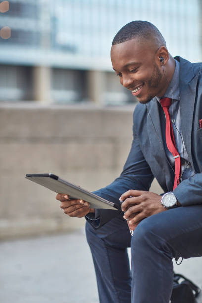 istock Happy businessman using digital tablet in city 924719610