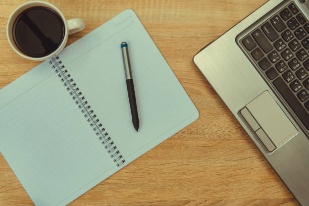 istock Laptop computer or notebook, note and cup of coffee on working table with copy space top view. 924720338
