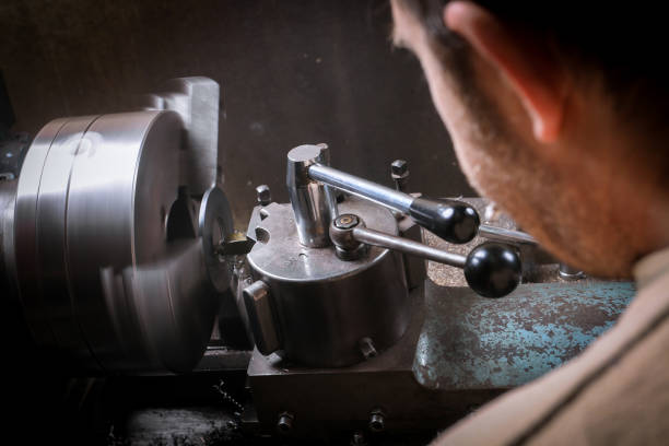 istock Metal worker shaping metal on lathe 924724158