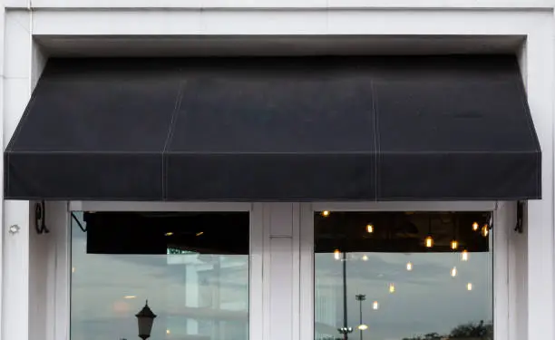 Photo of black awning over cafe windows