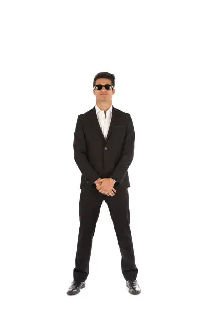 Studio portrait of a handsome man wearing an elegant suite and posing on white background.