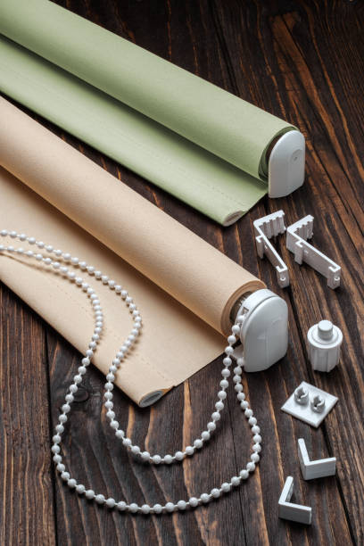istock The beige rolled blind is on a wooden surface. 924727334