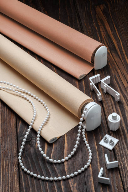 istock The beige rolled blind is on a wooden surface. 924727392