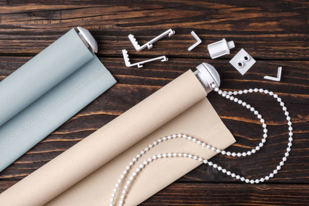 istock The beige rolled blind is on a wooden surface. 924727454