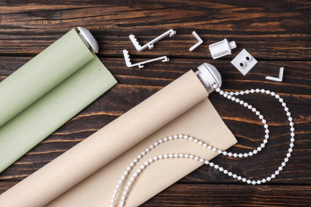 istock The beige rolled blind is on a wooden surface. 924727490