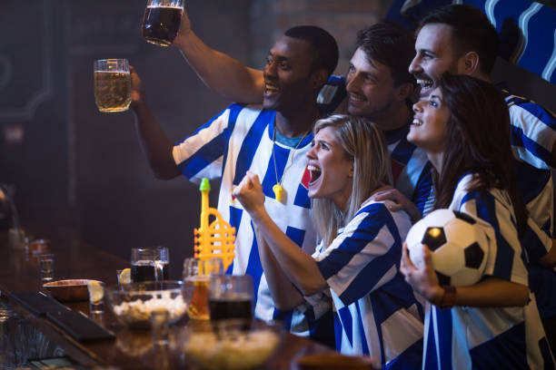 istock Happy friends having fun while drinking beer in a bar and cheering for their soccer team. 924727616