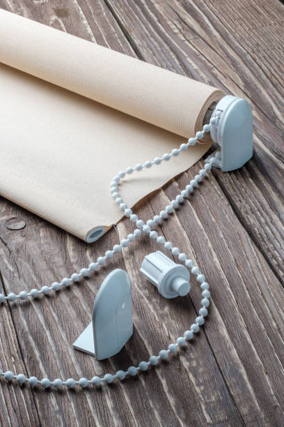 istock The beige rolled blind is on a wooden surface. 924727670